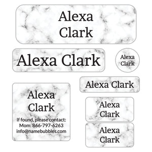school supply labels of various shapes and sizes with white marble background